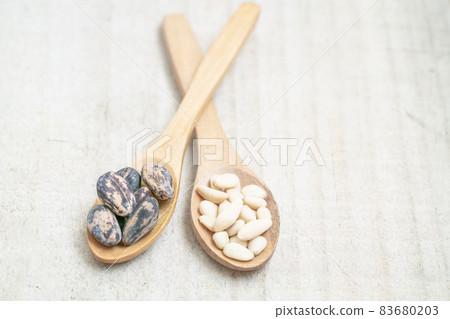shelled and whole pine nuts in spoon on the wooden background with copy space shelled and whole pine nuts in spoon on the wooden background with copy space 83680203