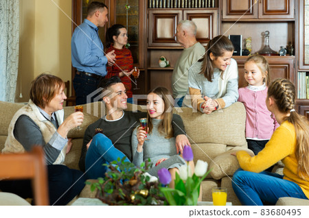 Happy family having conversation together Happy family having conversation together 83680495