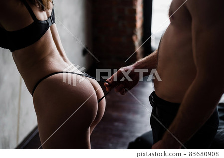 Close-up of unrecognizable man passionately pressed against the back of a woman in panties. cropped photo of a pair of lovers in foreplay. Close-up of unrecognizable man passionately pressed against the back of a woman in panties. cropped photo of a pair of lovers in foreplay. 83680908