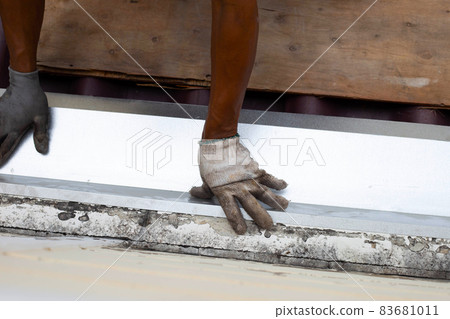 Roof repair, Worker with steel sheet. Stop a roof leak Roof repair, Worker with steel sheet. Stop a roof leak 83681011