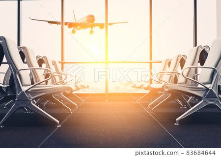 Empty chair in airport terminal gate with window sunset light background. Travel adventure and vacation freedom concept. 83684644