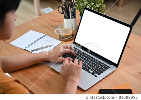 Young asian man working online with laptop computer. 83688958