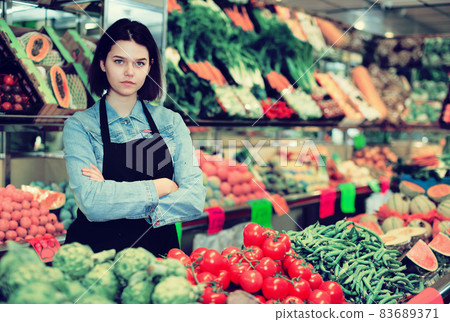 Female seller displaying assortment 83689371