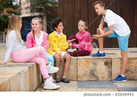 Company of children are communicating on walk Company of children are communicating on walk 83689443