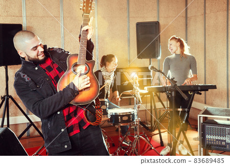 Emotional guy with guitar rehearsing Emotional guy with guitar rehearsing 83689485