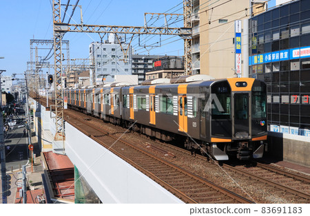 Hanshin 1000 series train passing through Kawachi-Kosaka Station on the Kintetsu Nara Line 83691183