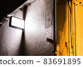 Building walls illuminated by fashionable street lights 83691895