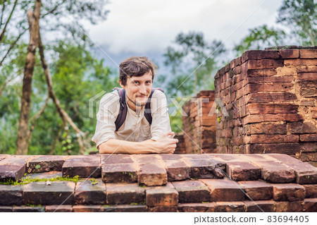Man tourist in Temple ruin of the My Son complex, Vietnam. Vietnam opens to tourists again after quarantine Coronovirus COVID 19 Man tourist in Temple ruin of the My Son complex, Vietnam. Vietnam opens to tourists again after quarantine Coronovirus COVID 19 83694405