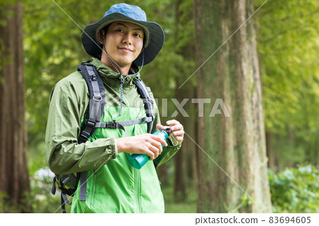 Young man enjoying a hike Young man enjoying a hike 83694605