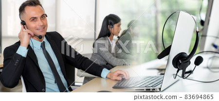 Business people wearing headset working in office broaden view Business people wearing headset working in office broaden view 83694865