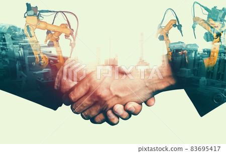 Mechanized industry robot arm and business handshake double exposure Mechanized industry robot arm and business handshake double exposure 83695417
