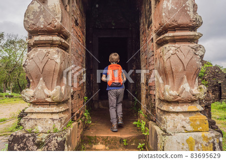 Boy tourist in Temple ruin of the My Son complex, Vietnam. Vietnam opens to tourists again after quarantine Coronovirus COVID 19 Boy tourist in Temple ruin of the My Son complex, Vietnam. Vietnam opens to tourists again after quarantine Coronovirus COVID 19 83695629