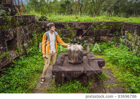 Man tourist in Temple ruin of the My Son complex, Vietnam. Vietnam opens to tourists again after quarantine Coronovirus COVID 19 83696786