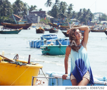 cute smiling young real woman in asian country sea port, vietnam traveller lifestyle 83697282