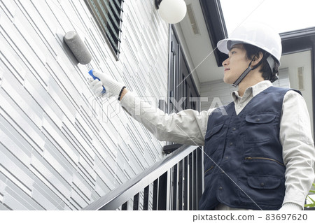 Men painting the exterior walls 83697620