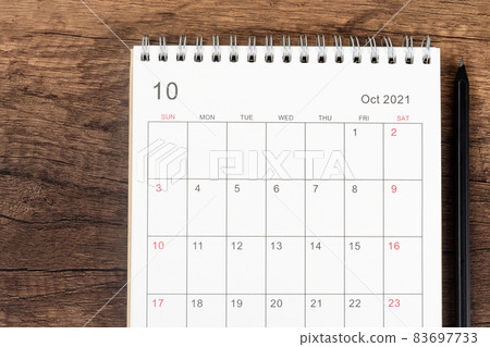 Top view calendar desk 2021, Calendar planning in October month and pencil on wooden table background. 83697733