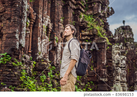 Man tourist in Temple ruin of the My Son complex, Vietnam. Vietnam opens to tourists again after quarantine Coronovirus COVID 19 Man tourist in Temple ruin of the My Son complex, Vietnam. Vietnam opens to tourists again after quarantine Coronovirus COVID 19 83698153