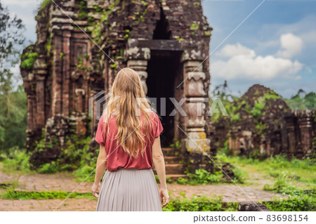 Woman tourist in Temple ruin of the My Son complex, Vietnam. Vietnam opens to tourists again after quarantine Coronovirus COVID 19 Woman tourist in Temple ruin of the My Son complex, Vietnam. Vietnam opens to tourists again after quarantine Coronovirus COVID 19 83698154