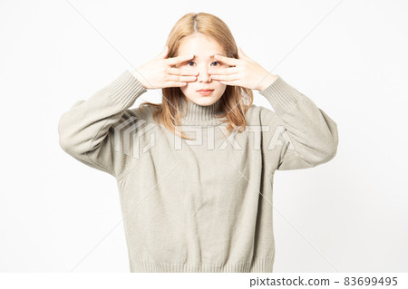 Young woman in a sweater that hides her eyes Young woman in a sweater that hides her eyes 83699495