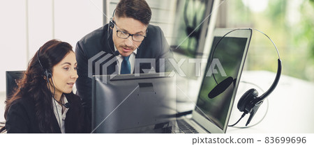 Business people wearing headset working in office broaden view Business people wearing headset working in office broaden view 83699696