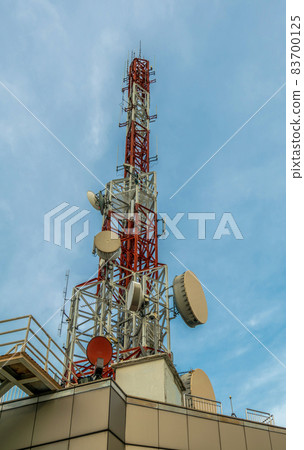 Large telecommunication tower against sky and clouds in background 83700125