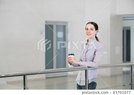 young attractive business woman with a cup of coffee young attractive business woman with a cup of coffee 83701077