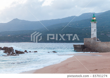 Lighthouse tower with green top and light on. Corsica 83701274