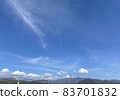 Blue sky and mountains and airplane clouds 83701832