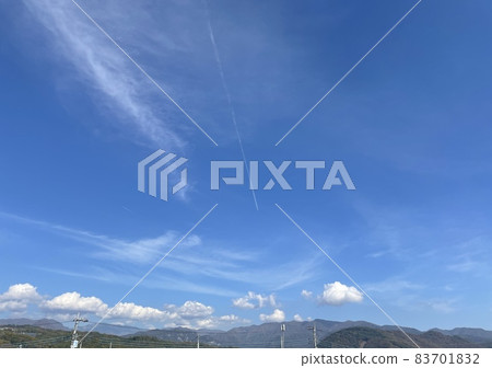 Blue sky and mountains and airplane clouds Blue sky and mountains and airplane clouds 83701832