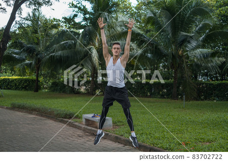 Sporty active young man in sportswear doing sport exercises in the park. Happy fit man jumping outdoors. Healthy lifestyle concept, sport outdoor Sporty active young man in sportswear doing sport exercises in the park. Happy fit man jumping outdoors. Healthy lifestyle concept, sport outdoor 83702722