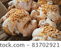 Tasty traditional polish croissants  - Croissant of Saint Martin (Rogal Swietomarcinski) with white poppy seeds and nuts on a wooden table in rustic style 83702921