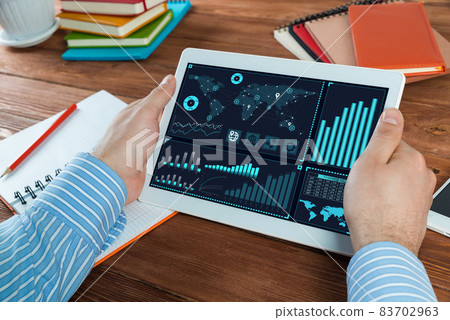 Businessman with a computer tablet at a work desk Businessman with a computer tablet at a work desk 83702963