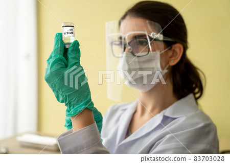 Skillful doctor prepare vaccine proficiently before injection Skillful doctor prepare vaccine proficiently before injection 83703028