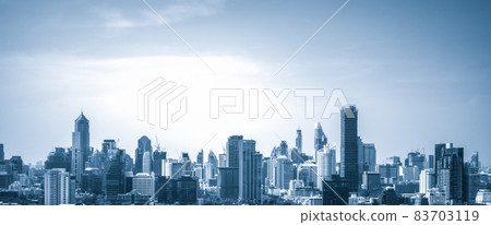 Blue-filtered cityscape and high-rise buildings in metropolis city center 83703119