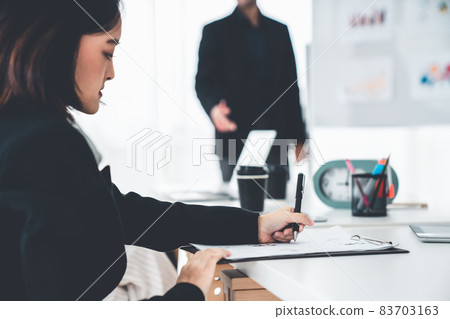 Businesswoman in business meeting writing paper proficiently at office room . Businesswoman in business meeting writing paper proficiently at office room . 83703163