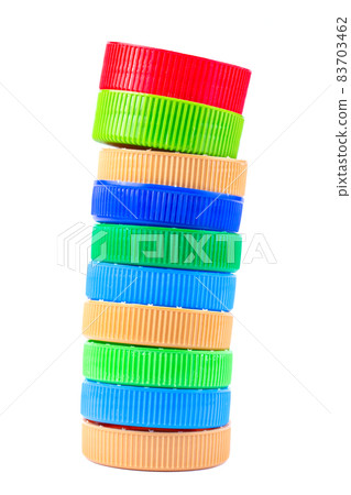 Pile of colored plastic caps isolated on white background. Recycling concept. 83703462