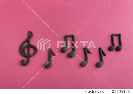 Treble clef and music notes on pink background. Music symbol. Key of G. Violin key. Musical notation. Treble clef and music notes on pink background. Music symbol. Key of G. Violin key. Musical notation. 83705490