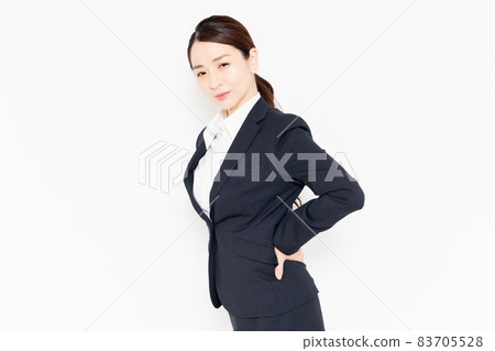 A business woman who puts her hand on her back due to back pain A business woman who puts her hand on her back due to back pain 83705528