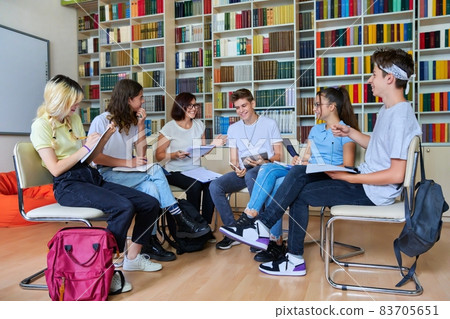 Group of teenagers with middle aged female teacher at library Group of teenagers with middle aged female teacher at library 83705651