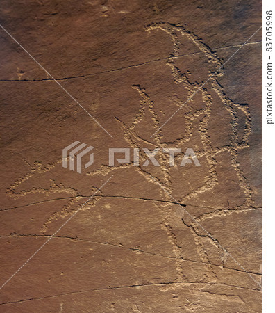 An ancient petroglyph of hunter with bow and silhouette of running animal. An ancient petroglyph of hunter with bow and silhouette of running animal. 83705998