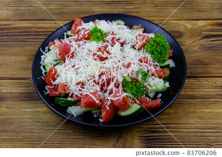 Traditional Bulgarian Shopska salad on wooden table Traditional Bulgarian Shopska salad on wooden table 83706206