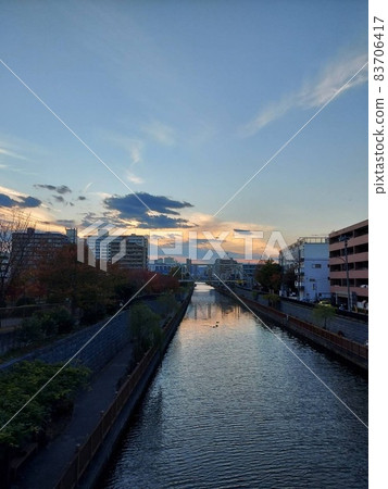 Sunset, cityscape and river Sunset, cityscape and river 83706417