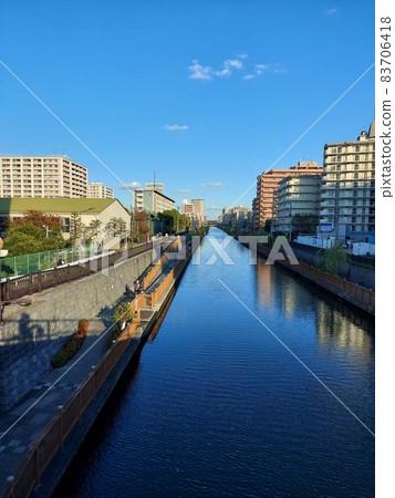 Blue sky reflecting on the river Blue sky reflecting on the river 83706418