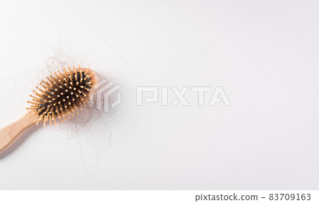 Healthcare problem concept. Hair loss or hair fall in comb on white background. Healthcare problem concept. Hair loss or hair fall in comb on white background. 83709163