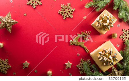 Christmas and new year background concept. Top view of Christmas gift box, reindeer, christmas ball and snowflake on red background. 83709165