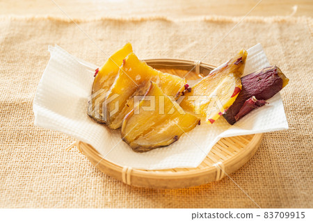 Dried potatoes on a bamboo basket Dried potatoes on a bamboo basket 83709915