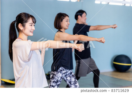 Men and women boxing at the gym Men and women boxing at the gym 83711629