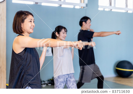 Men and women boxing at the gym Men and women boxing at the gym 83711630