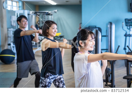 Men and women boxing at the gym Men and women boxing at the gym 83712534