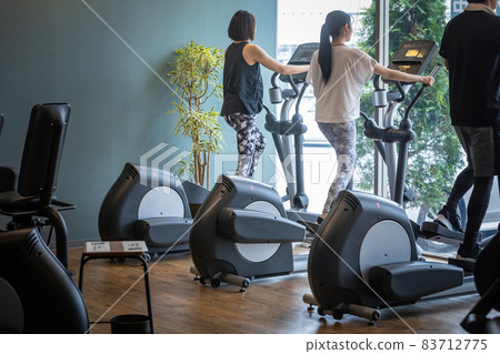 Men and women exercising in the gym Men and women exercising in the gym 83712775